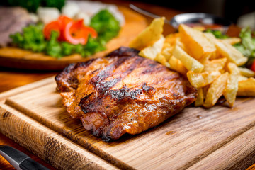 Beef steak with pepper sauce and Grilled vegetables on cutting board  dark wooden background