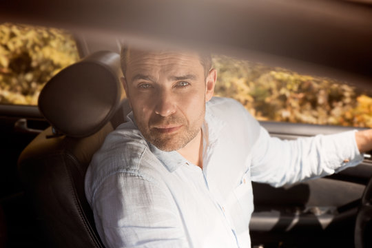 Man sitting in car