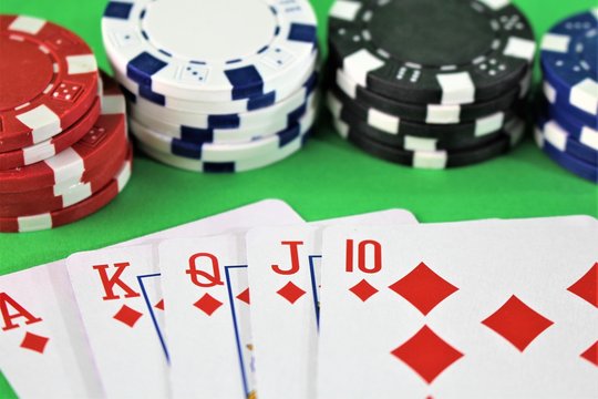 An image of a royal flah - poker, chips