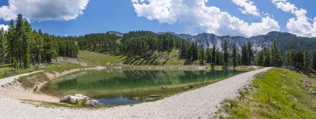 Lake on mountain Petzen with forrest and mountain Hochpetzen in the background