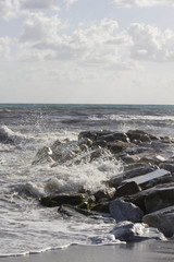 Waves crashing into rocks in Marina di Massa, Italy