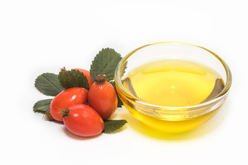 Rose hip oil isolated on white background.
