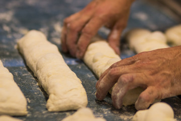 Homem fazendo pão francês em padaria no Brasil foco seletivo