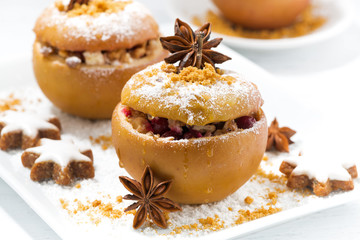 festive baked stuffed apples and gingerbread on white plate