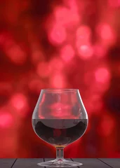 Fotobehang 3d rendering. whiskey in the glass with blurred red bokeh as background © PATARA