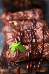Chocolate eclair decorated with mint and melted chocolate