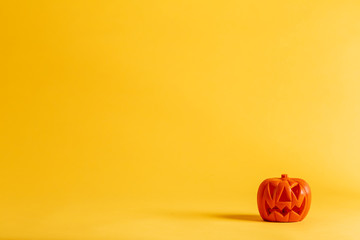 Halloween pumpkin decoration on a yellow-orange background