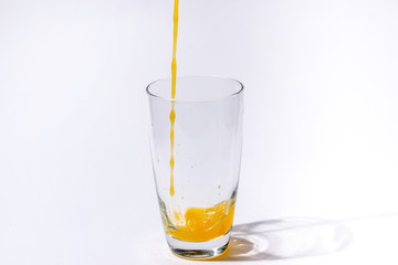 splashing orange juice with oranges against white background By showcake