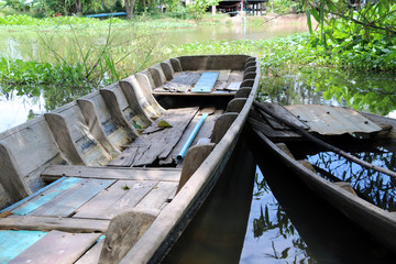 Local sampan boat of Thailand in the canal, One available and another one not available because boat Leak, Full of water inside.