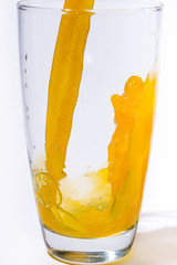 splashing orange juice with oranges against white background By showcake