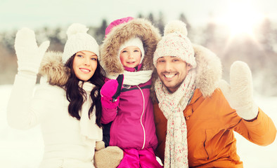 Fototapeta premium happy family waving hands outdoors in winter