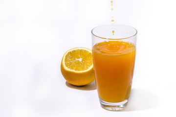 splashing orange juice with oranges against white background By showcake