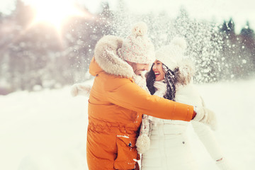 happy couple hugging and laughing in winter