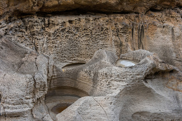 Holes excavated by water in Wied il Mielah canyon. Gozo, Malta