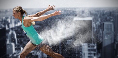 Fototapeta na wymiar Composite image of sportswoman finishing her run
