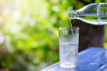 Pouring water from a bottle into a glass