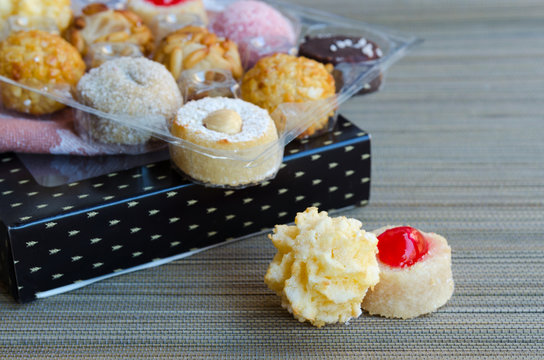 Different Panellets on wooden background. Typical sweets consumed at All Saints Day (Dia Todos Los Santos)  in Catalonia, Spain. Catalan  cakes or cookies made mainly of marzipan rolled in pine nuts.