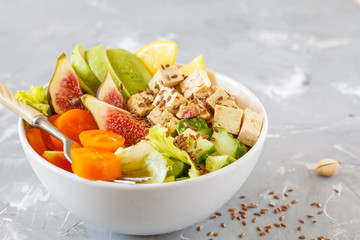 buddha bowl with tofu, figs, avocado and other vegetables, tahini filled