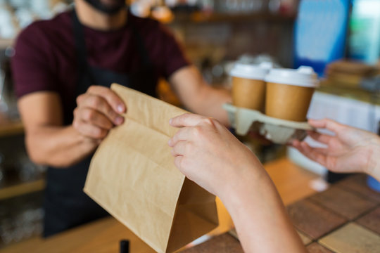 Man Or Bartender Serving Customer At Coffee Shop