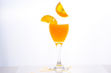 Orange juice splashing out of glass., Isolated white background.