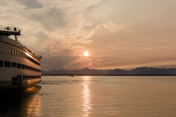 Fototapeta na wymiar Ferry boat at sunset on Elliott bay near Seattle