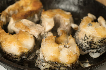 Fried fish steaks in pan. Fry big pike fish in a frying pan.