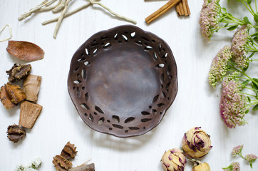 Dark brown burned clay dishes. Ceramics on the white background. Decorative pottery