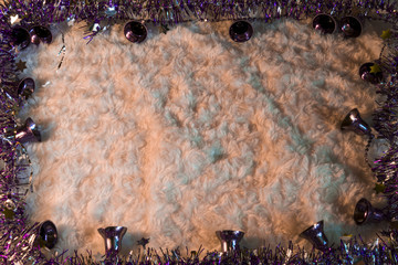 Free space for text on white background surrounded by purple tinsel and christmas bells.