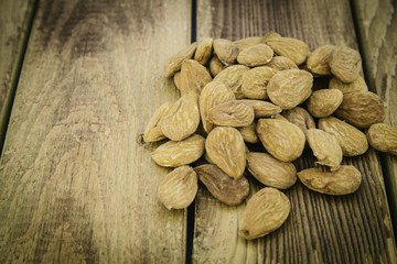 Group of almonds nuts in a wooden table
