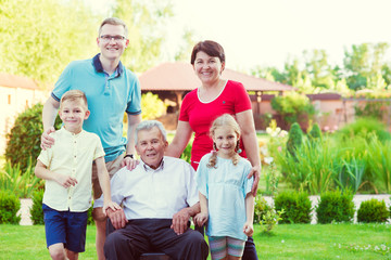 Fototapeta premium Portrait of big happy family with old grandfather, his daughter and his grandchildren