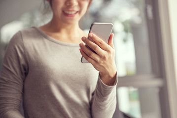 Woman hand holding mobile phone, She using in mobile applications and multimedia programs