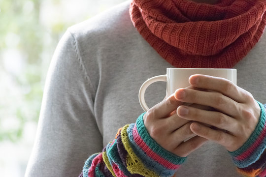 A young man holding a Cup of tea and lemon. Cold, cold, disease.