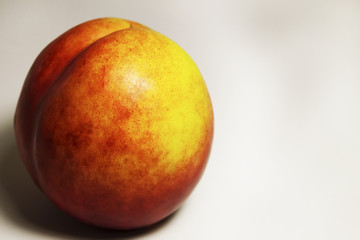 One sweet peach on white background