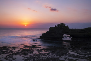 Silhouette temple on a strong cliff in a beautiful twilight at Pure Batu Bolong, Bali, Indonesia