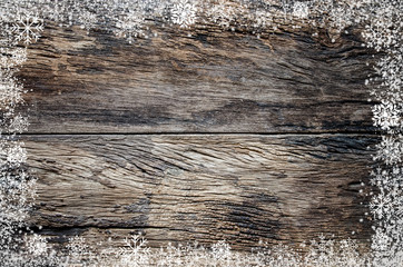 Brown wooden texture with white snow flake. Christmas holidays background.