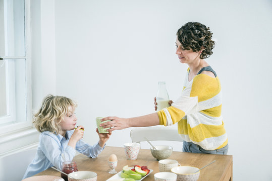 Mother and daughter have breakfast together