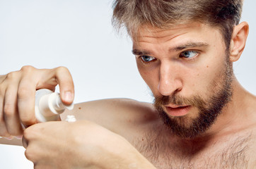 Obraz premium man squeezes cosmetic cream on hand