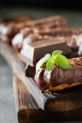 Chocolate eclair decorated with mint and melted chocolate