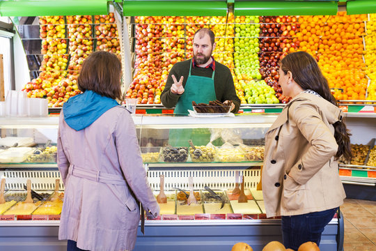 Female customers shopping in greengrocer's shop