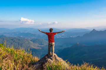 Male Hipster Traveler stand on the stone with beautiful mountain landscape background, adventure, travel, tourist concept