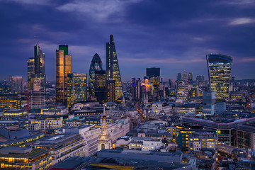 London, England - Panoramic skyline view of Bank district of London with the skyscrapers of Canary Wharf at the background at blue hour