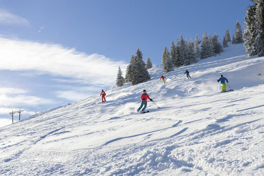 Ski holiday, Group of skiers carving downhill, Sudelfeld, Bavaria, Germany