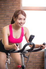 Fototapeta premium woman use exercise bike