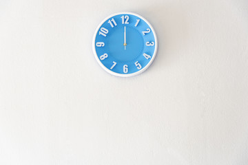 noon or midnight time with 12:00 clock on white concrete wall interior background with copy space, message board concept. Noon is the lunch time , Midnight is the bed time