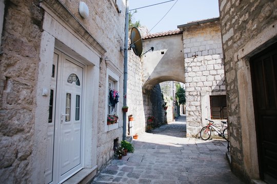 Antique ancient streets of croatian village made from old white bricks, small doors lead to rustic and atmospheric hotels