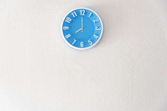 Good morning or night time with 8:00 clock on white concrete wall interior background with copy space, message board concept. Good morning is the greeting in the morning, 8am is the working time