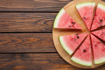 watermelon slices on dark wooden background top view