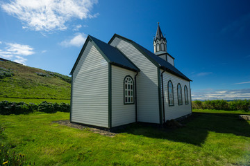 Fototapeta na wymiar Iceland - Ancient church building of blonduos chapel on green meadow