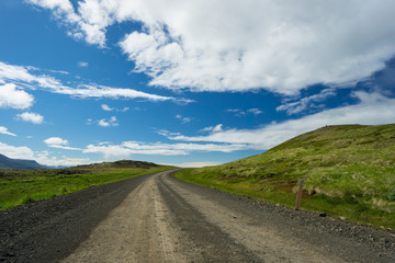 Fototapeta na wymiar Iceland - Lonely path through green countryside of hills with nobody