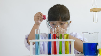 Asian children girl testing chemical in laboratory.